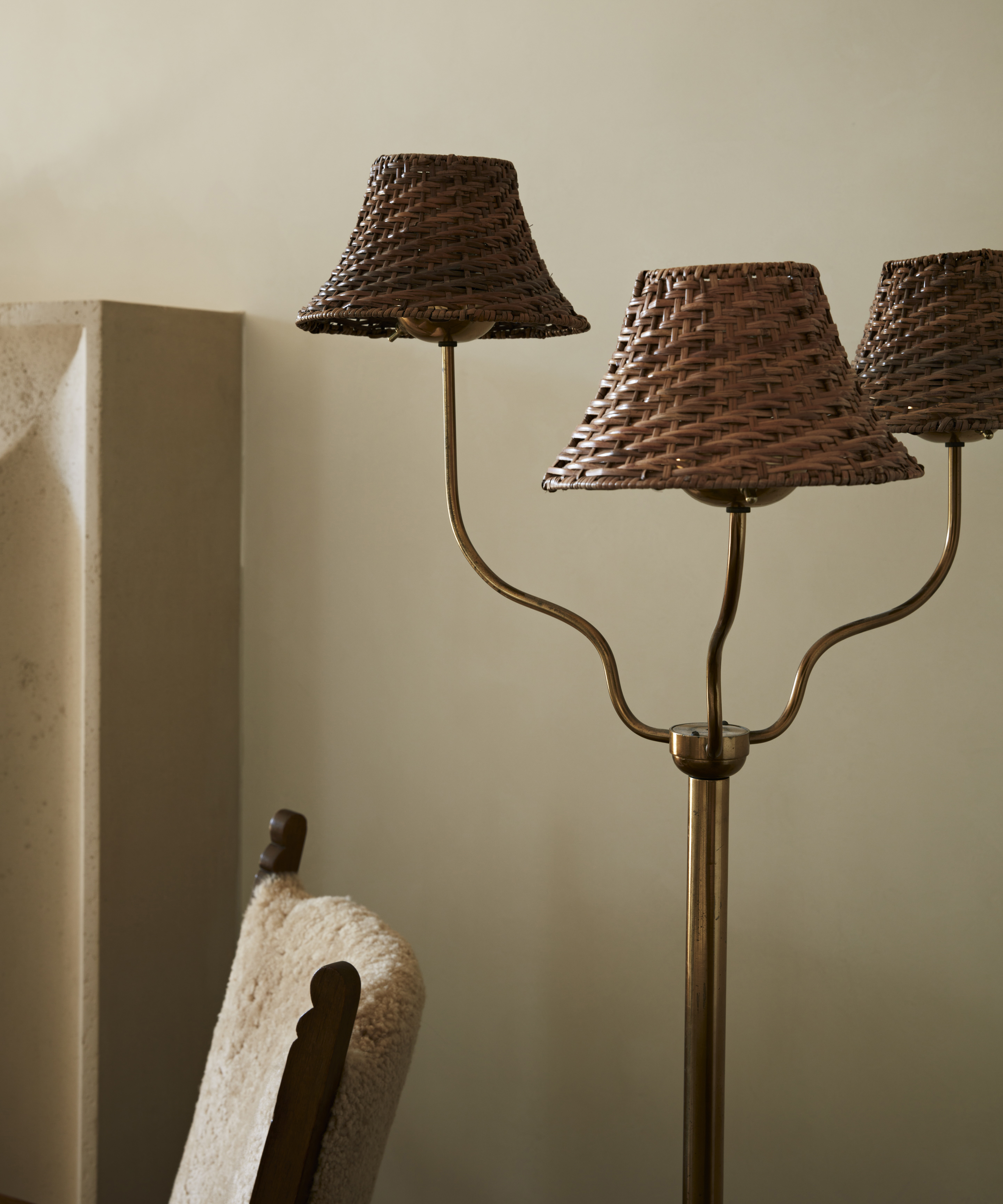 Antique three-light floor lamp in a neutral living room