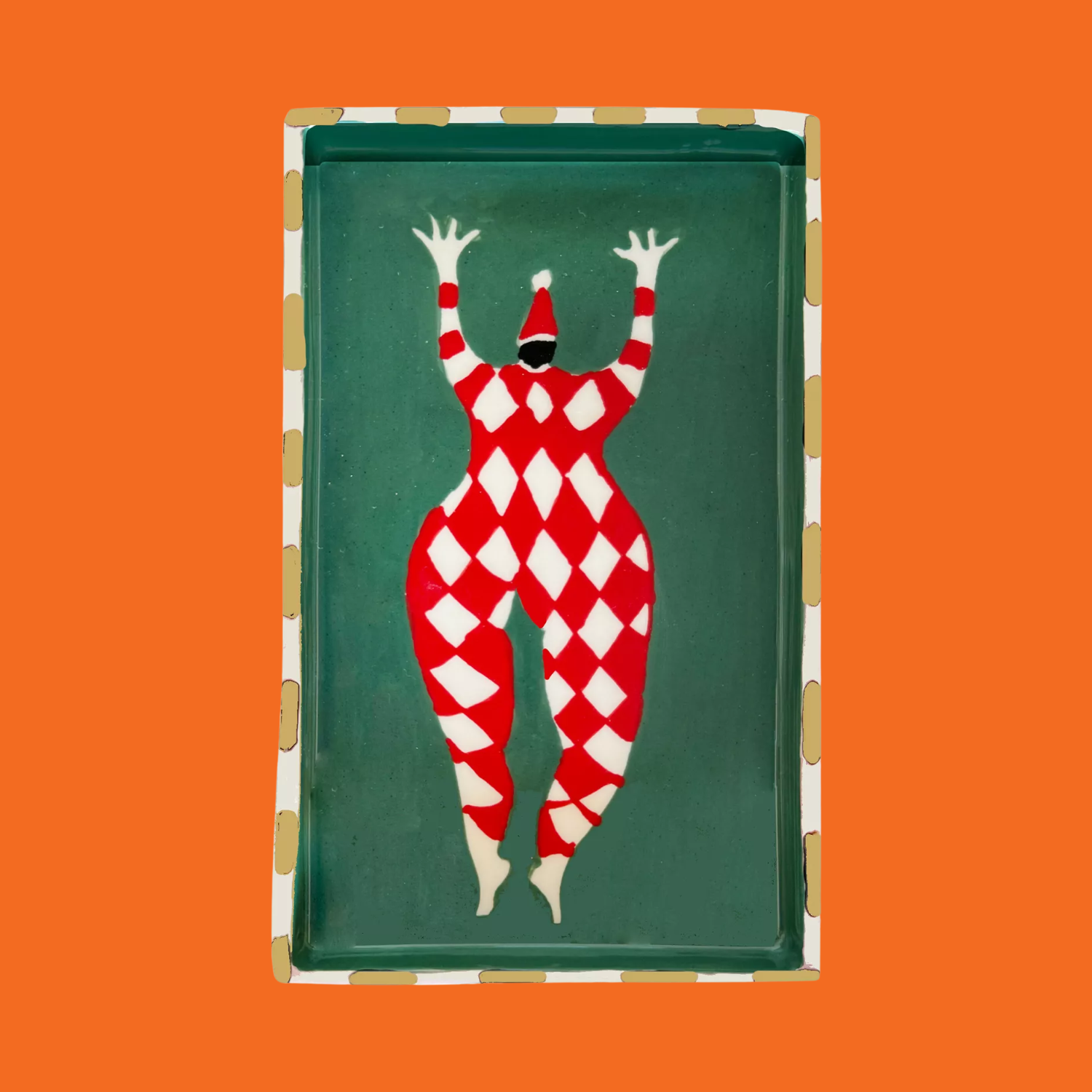 A colorful tray with a Harlequin style Santa Claus drawing